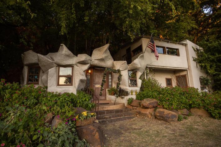 Image of Cave House, a unique roadside structure that looks rocky and cave-like.